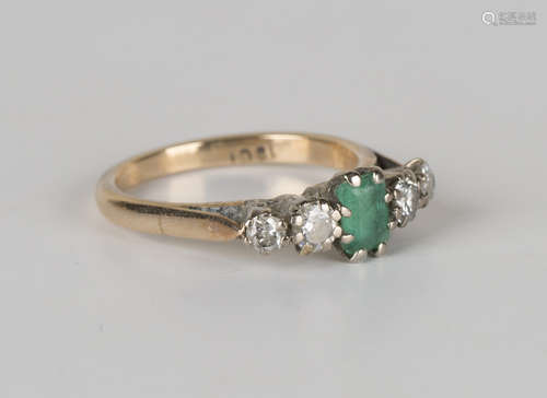 A gold, emerald and diamond five stone ring, mounted with a rectangular cut emerald between two