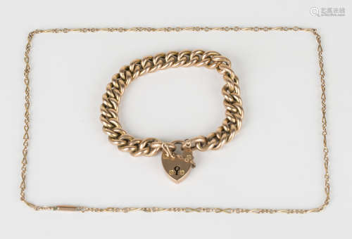 A gold hollow curblink bracelet, detailed '9ct', on a 9ct gold heart shaped padlock clasp,