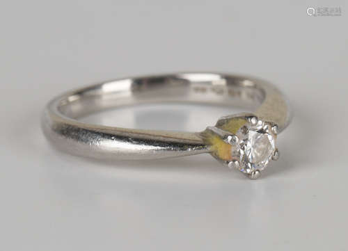 A platinum and diamond single stone ring, claw set with a circular cut diamond, detailed '033', ring