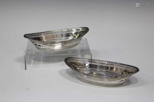 A pair of Edwardian silver oval bonbon dishes, each with pierced sides and beaded rim, London 1904