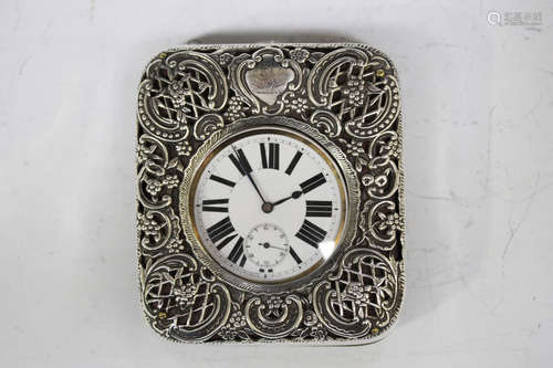 A late Victorian silver mounted travelling watch case, pierced and embossed with 'C' scrolls and