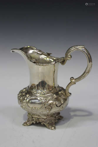 An early Victorian silver milk jug, the low-bellied body chased with scrolling foliage, London