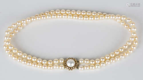 A two row necklace of uniform cultured pearls on a 9ct gold and mabé pearl clasp, length of shortest