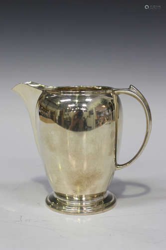 A George VI silver cream jug, the ovoid body raised on a stepped circular foot, Sheffield 1937 by