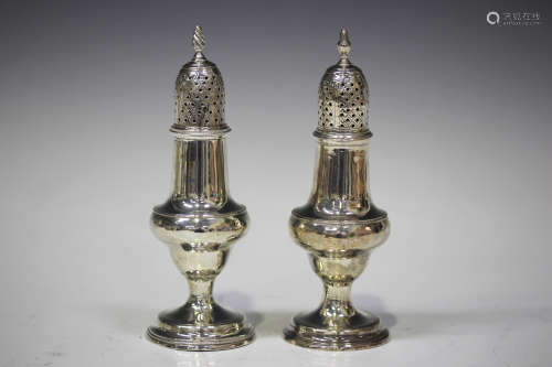 A George III silver caster of baluster form with pierced domed cover and spiral finial, on a
