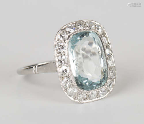 An aquamarine and diamond curved rectangular cluster ring, collet set with a curved rectangular