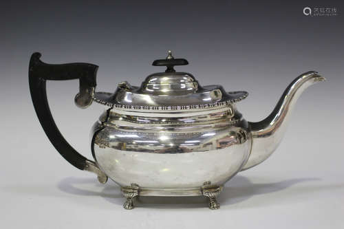 A George V silver teapot of cushion form with bead and reel rim, on paw feet, Sheffield 1928 by