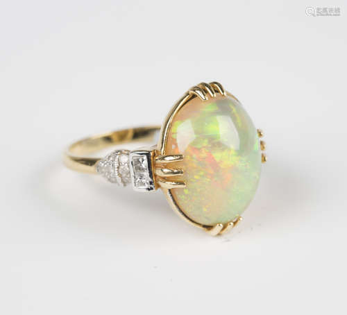 A gold, opal and diamond ring, claw set with the oval opal between princess cut and circular cut