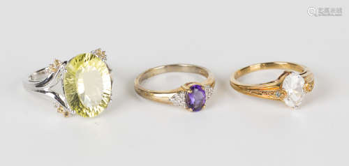 A 9ct gold ring, claw set with an oval cut amethyst between diamond six stone shoulders, ring size