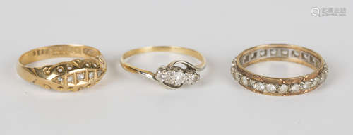 An 18ct gold and diamond five stone ring, Birmingham 1915, a gold and diamond three stone ring,