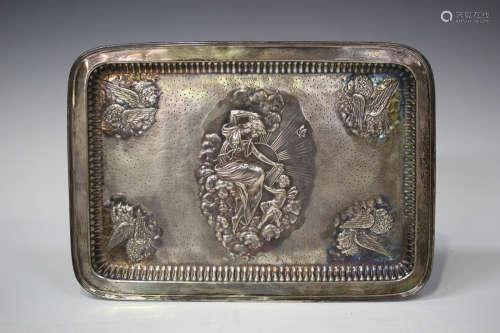 A late Victorian silver rectangular dressing table tray, embossed and engraved with a reclining
