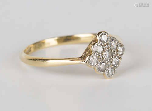 A gold, platinum and diamond nine stone cluster ring in a lozenge shaped design, mounted with