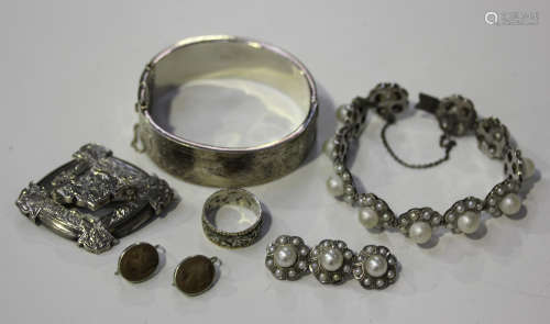 A pair of lava cameo earrings, length 2cm, a silver oval hinged bangle, Birmingham 1956, inside