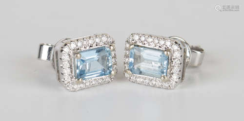 A pair of white gold, aquamarine and diamond earrings, each claw set with a rectangular cut