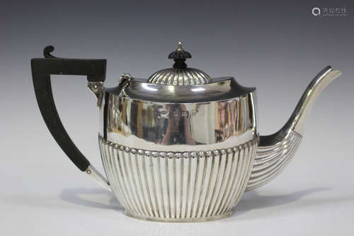 An Edwardian silver teapot of half-reeded oval form, Birmingham 1903 by William Devenport, height