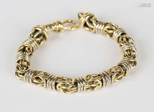 A two colour gold bracelet in a Byzantine style link design, on a gold sprung hook shaped clasp,