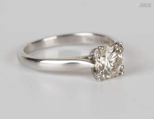 A platinum and diamond single stone ring, claw set with a circular cut diamond, ring size approx