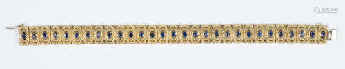 An 18ct gold and sapphire bracelet, formed as two-tier ropetwist wirework oval links, each centred