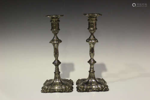 A pair of George V silver baluster candlesticks, each cylindrical sconce with detachable nozzle,