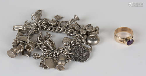 A silver curblink charm bracelet, fitted with a variety of mostly silver charms, including a curling