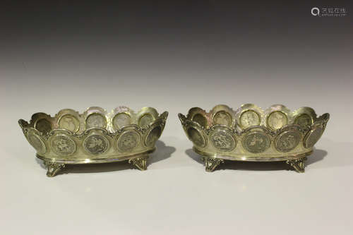 A pair of late Victorian silver oval bowls, each tapering side inset with a band of twelve