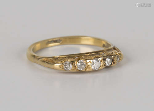 A gold and diamond five stone ring, mounted with a row of cushion cut diamonds graduating in size to