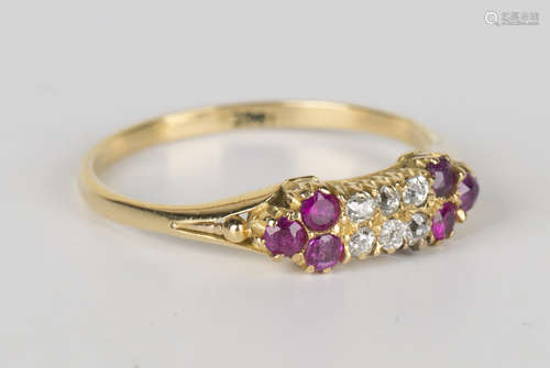 A gold, diamond and ruby ring, mounted with two rows of three cushion cut diamonds between ruby