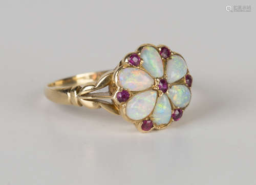 A gold, opal and ruby cluster ring, mounted with six opals and seven small cushion cut rubies at