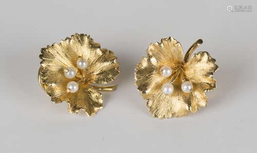 A pair of 18ct gold and cultured pearl earclips, each designed as a leaf with a textured finish,