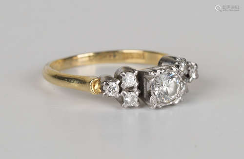 A gold and diamond ring, mounted with the principal circular cut diamond between circular cut