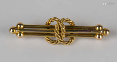 A gold bar brooch in an interlooped ropetwist and triple bar design with beaded terminals,