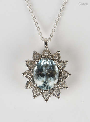 A white gold, aquamarine and diamond pendant, claw set with an oval cut aquamarine within a surround