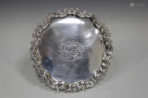 A George III Irish silver circular salver with cast scroll rim, the centre engraved with a dog