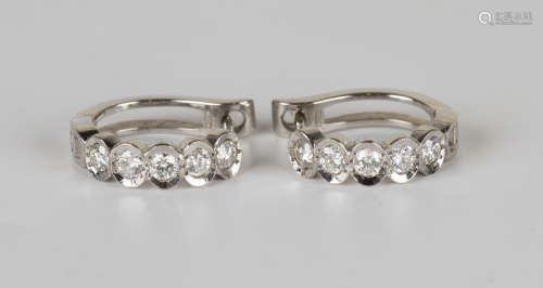 A pair of 18ct white gold and diamond earclips, each mounted with a row of five circular cut