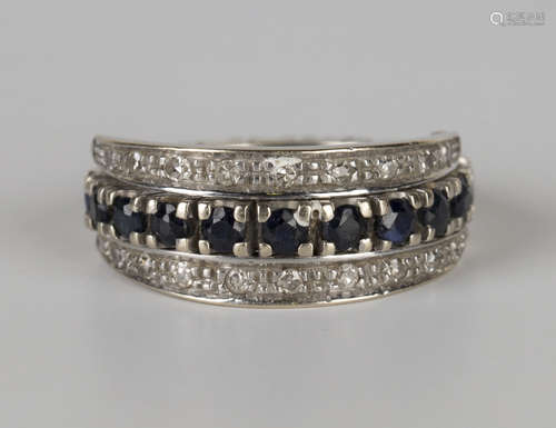 A white gold, ruby, sapphire and diamond swing-over eternity ring, the principal band mounted with