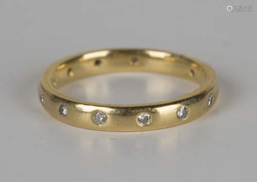 An 18ct gold and diamond eternity ring, mounted with circular cut diamonds, ring size approx M, with
