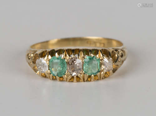 A gold, emerald and diamond five stone ring, mounted with two cushion cut emeralds alternating