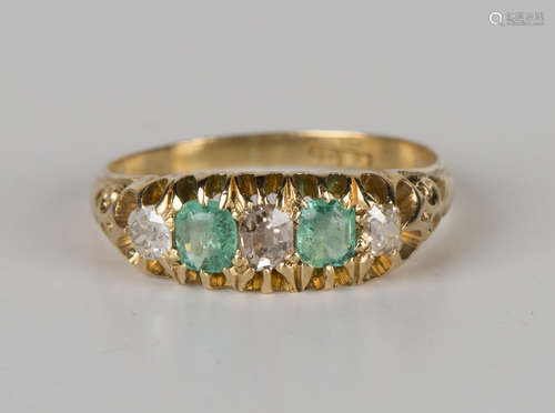 A gold, emerald and diamond five stone ring, mounted with two cushion cut emeralds alternating