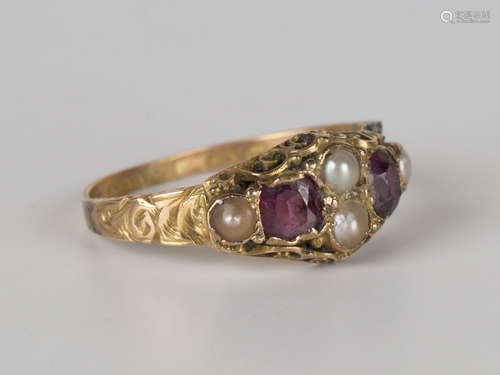 A Victorian 15ct gold, half-pearl and red gem set ring with engraved decoration and scrolled