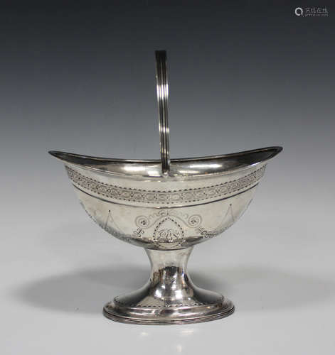 A George III Irish silver oval sugar basket with swing handle, bright-cut engraved with festoons