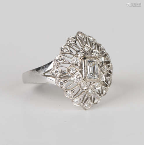 A white gold and diamond ring in an oval filigree cluster design, mounted with the principal