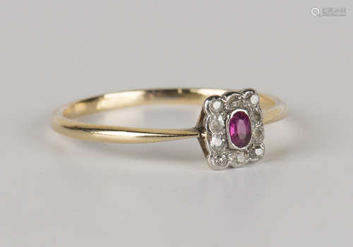 A gold, ruby and diamond rectangular cluster ring, mounted with an oval cut ruby within a surround