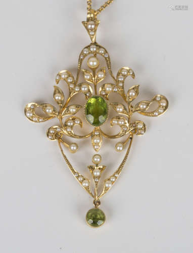 A 15ct gold, peridot and seed pearl pendant, circa 1910, in a scroll pierced and foliate design,
