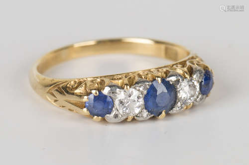 A gold, sapphire and diamond five stone ring, mounted with three cushion cut sapphires alternating