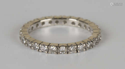 A white gold and diamond full eternity ring, mounted with circular cut diamonds, detailed '18K',