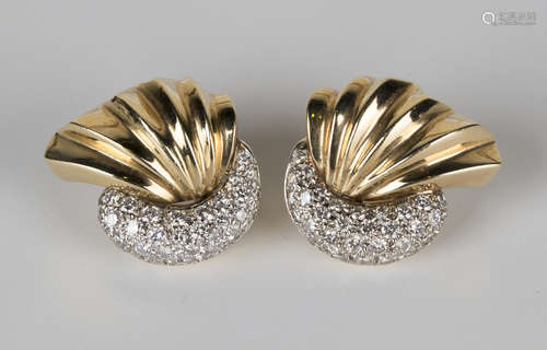 A pair of gold and diamond earrings, each in a stylized crescent and fan shaped design, set with