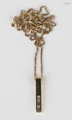 An 18ct gold pendant, mounted with three baguette cut diamonds, detailed 'D 017 750', length 2.