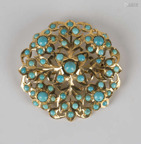 A gold and turquoise brooch of shaped circular form with floral and foliate pierced decoration,