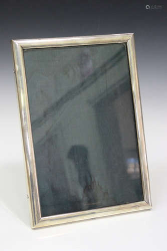 A sterling mounted rectangular photograph frame, detailed 'Sterling', height 34.3cm.Buyer’s