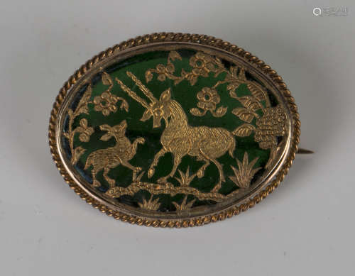 A gold mounted Indian green Pertubghar glass oval brooch, decorated with an antelope and calf and